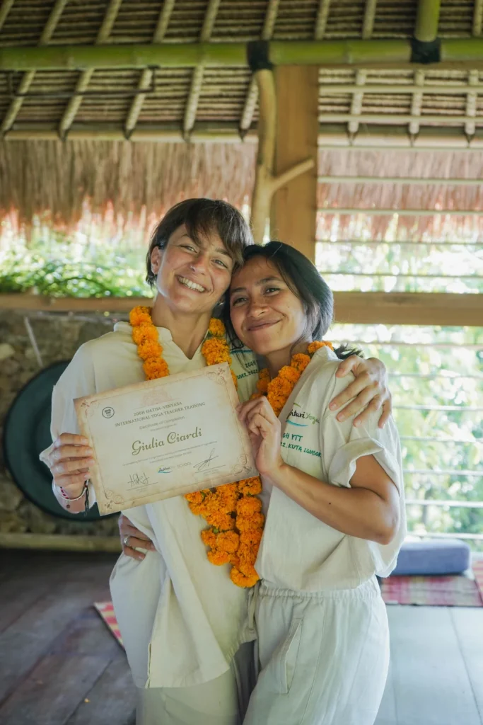 Closing ceremony at Ashtari Yoga in Kuta Lomok. Instructor hands over Yoga Alliance Certificate to student. 