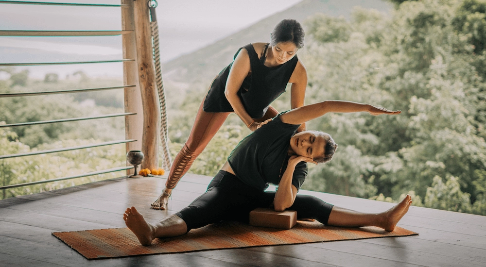 Yin Yang yoga lesson performed by Almitra at Ashtari yoga shala in Kuta Lombok surrounded by green tropical nature and seaside view