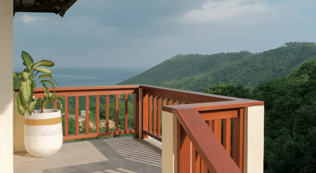 The loft entrance is surrounded by green nature and a beautiful sea side view.